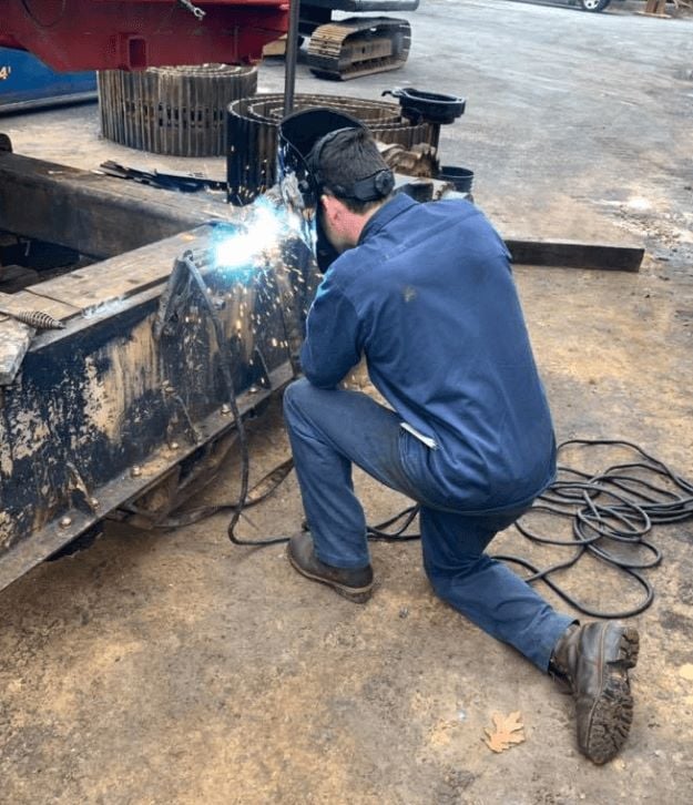 Flaherty worker repairing a crane